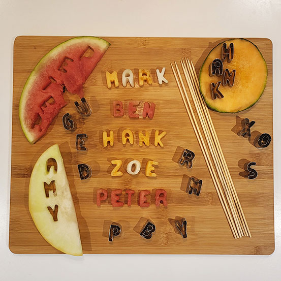 names cut out of melon slices with alphabet cutters