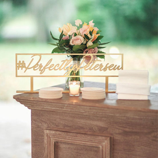 Perfectly Petersen freestanding tabletop custom hashtag sign on a wedding bar top