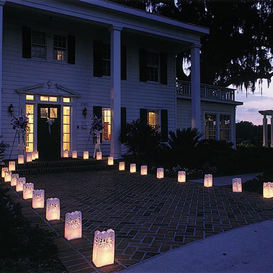 paper luminaries lining the path to the entrance of a house