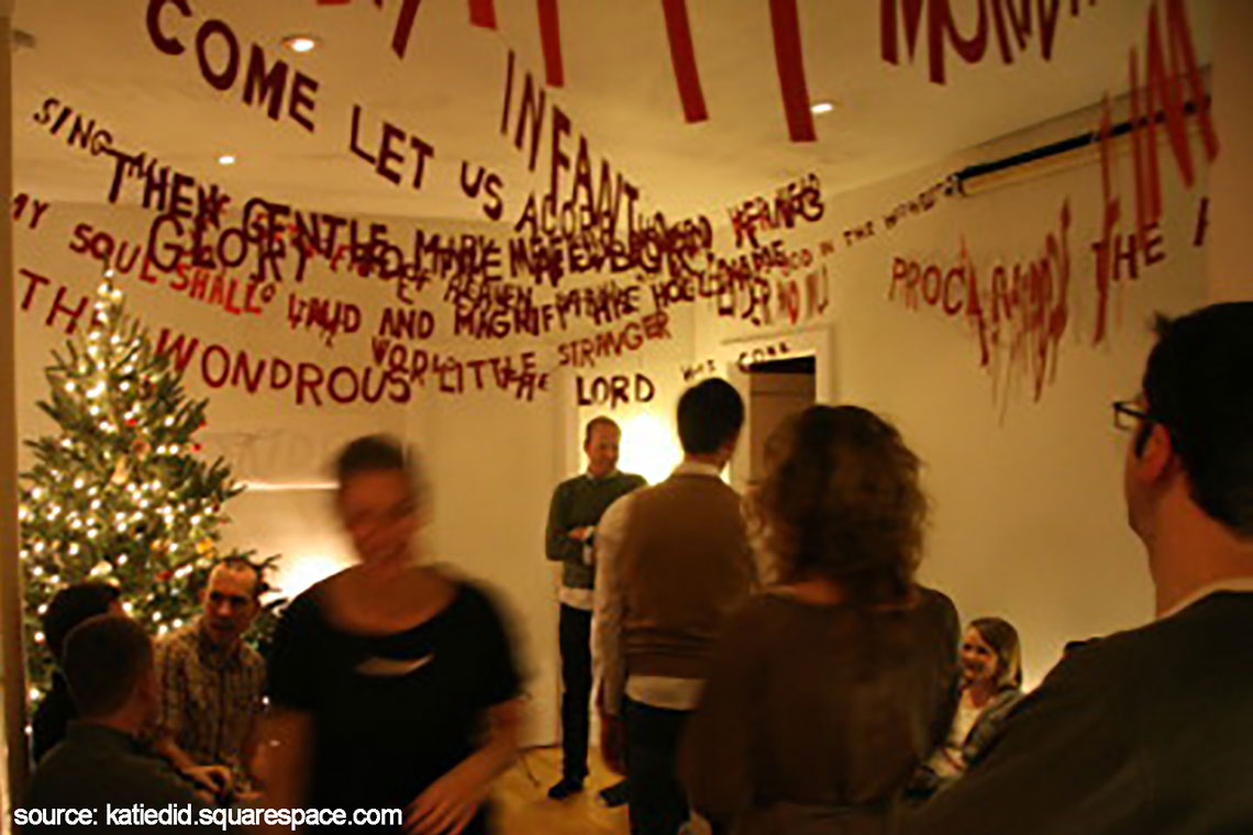 text banners of Christmas carol lyrics hung from ceiling at holiday party