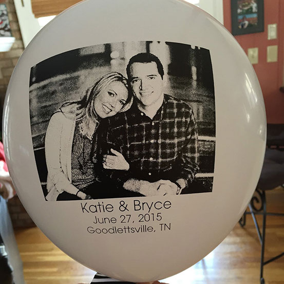 Picture of couple printed onto a white latex balloon with their names, wedding date, and location