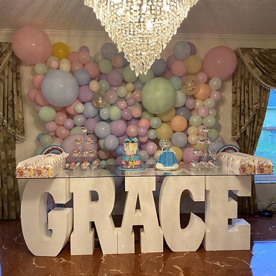 giant Styrofoam letters spelling the name GRACE used as a dessert table base