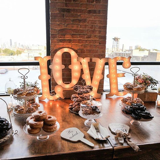 small marquee letters spelling LOVE on dessert table