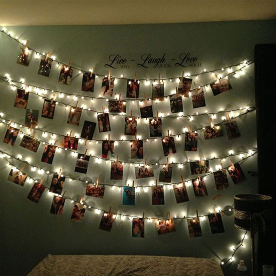 photos displayed on LED photo clip string lights against a wall