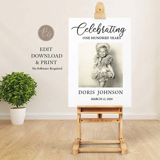 celebrating 100 years sign with photo of birthday boy as a baby displayed on an easel
