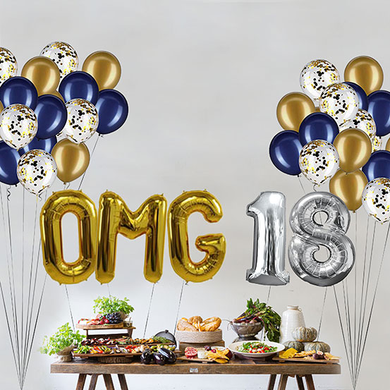 Giant gold and silver letter balloons spelling the phrase OMG 18 above a buffet table