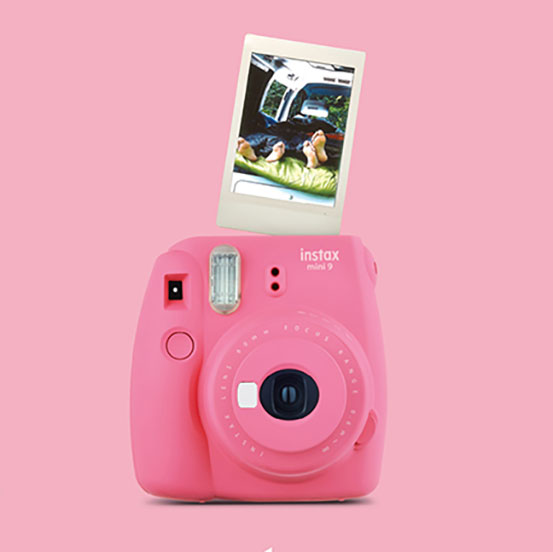 Pink Fujifilm Instax Mini 11 instant camera with photograph