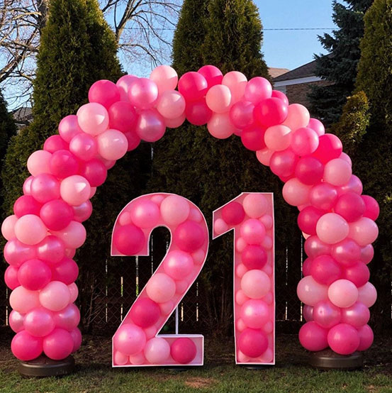21 balloon mosaic numbers filled with black balloons inside a house