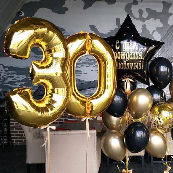 Giant number 30 balloons next to flowers