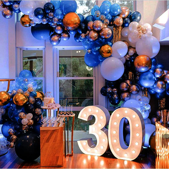 Large marquee letters spelling 30 surrounded by balloons