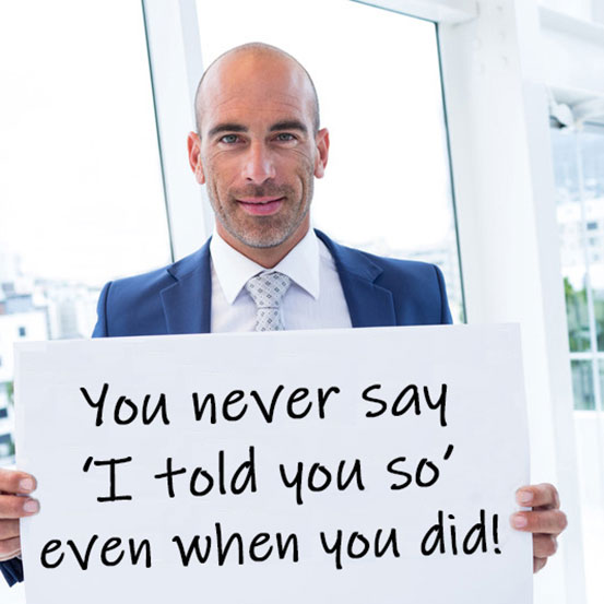 bald businessman in suit holding up sign explaining the reason he loves someone