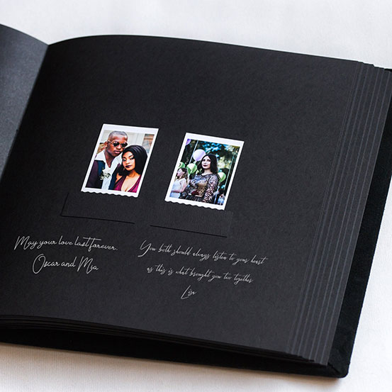 Open guest book with message and polaroid photo