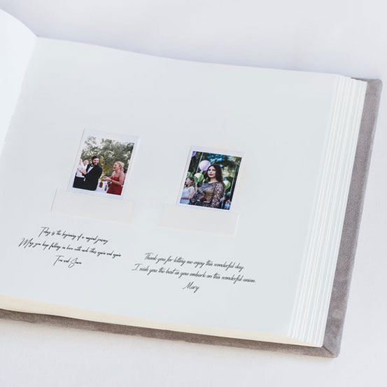 Open guest book with message and polaroid photo