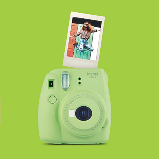 Pink Fujifilm Instax Mini 11 instant camera with photograph