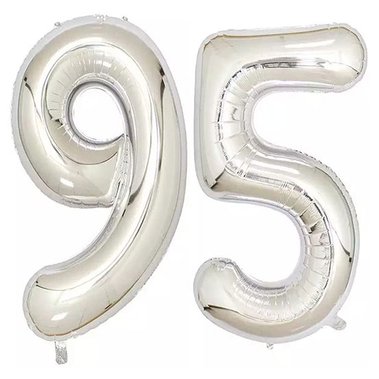 Giant number 95 balloons next to flowers