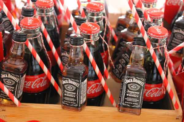 jack daniels and bottles of coke