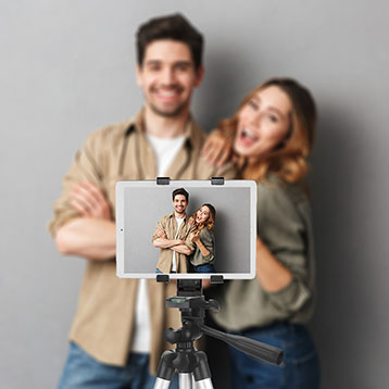 people recording a video message on tablet set up on tripod