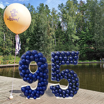 freestanding 95 balloon mosaic next to a lake