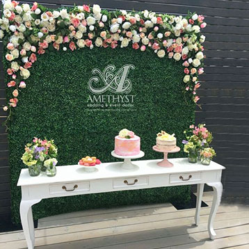 topiary dessert table backdrop decorated with flowers