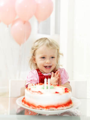 toddler girl with birthday cake