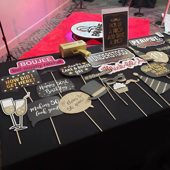 photo booth props and signs laid out on a table