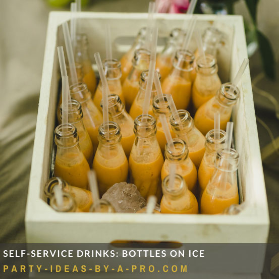 milk bottles filled with party drinks chilling in a crate of ice