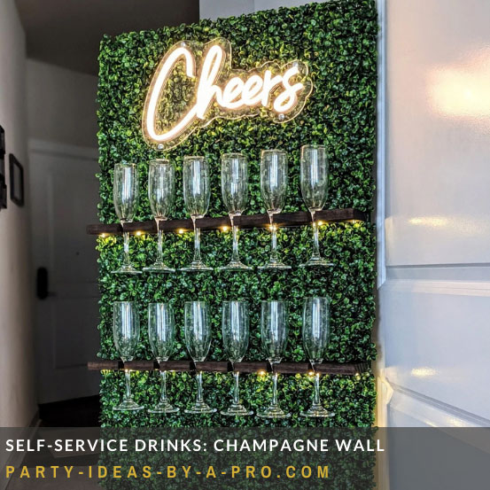 topiary lined freestanding champagne wall with cheers neon sign