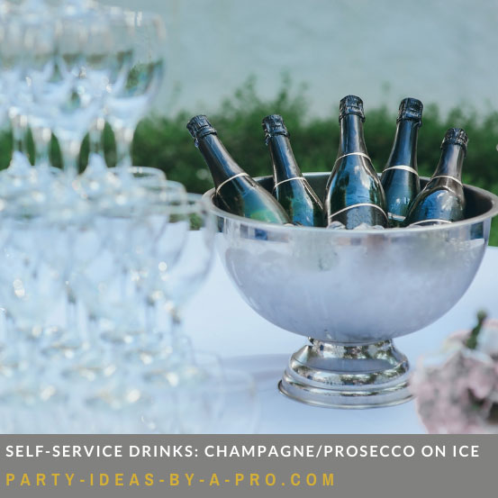 champagne bottles chilling in an ice bucket on an event bar