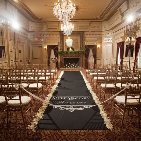 Personalized printed black fabric aisle runner at a wedding