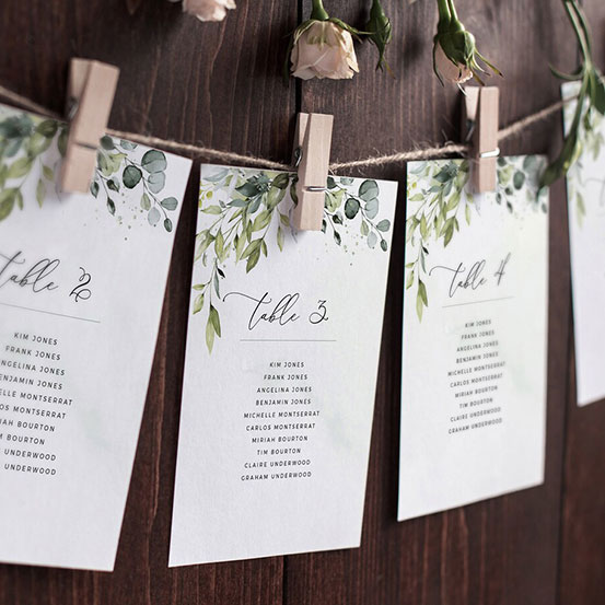 editable and printable wedding seating plan cards with foliage design pegged to twine