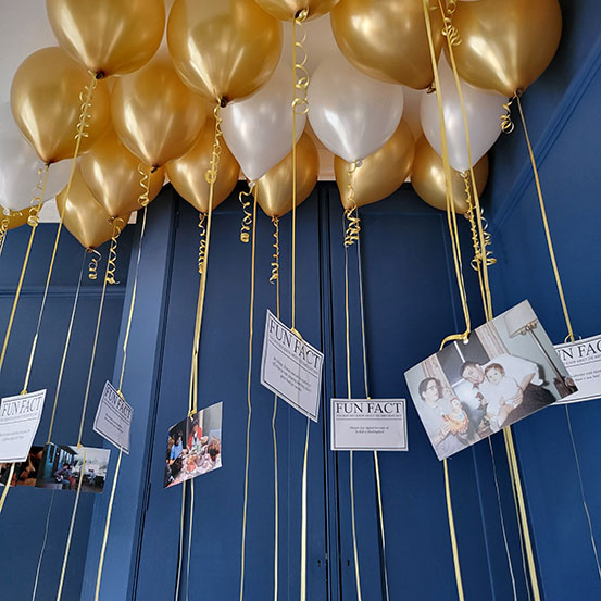 Fun Facts photos of the birthday boy/girl hanging from helium balloons