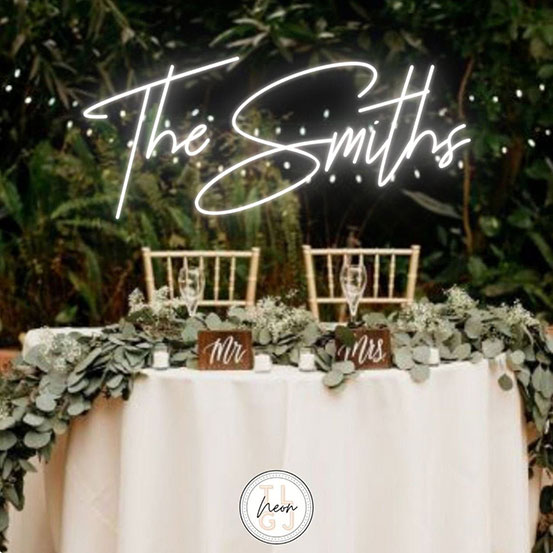 The Smiths custom neon sign above wedding top table