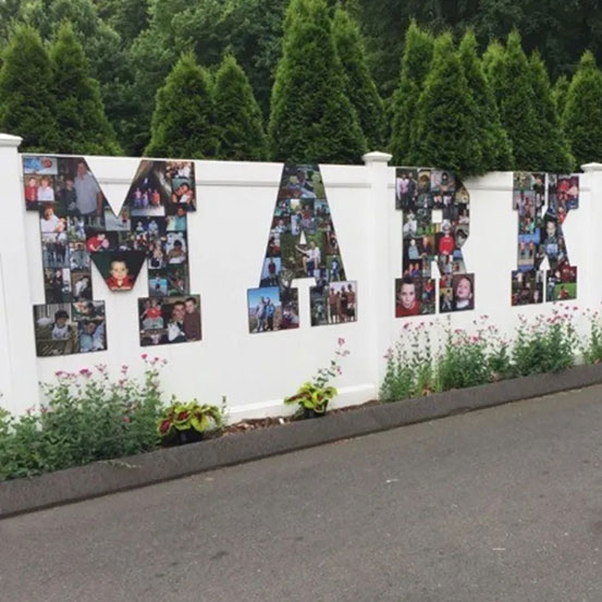 photo collage letters spelling the name Mark hung on garden fence