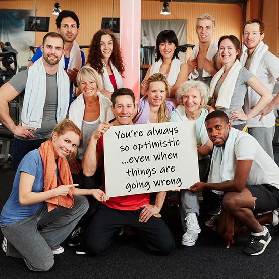 group of people at gym holding up sign explaining the reason they love someone