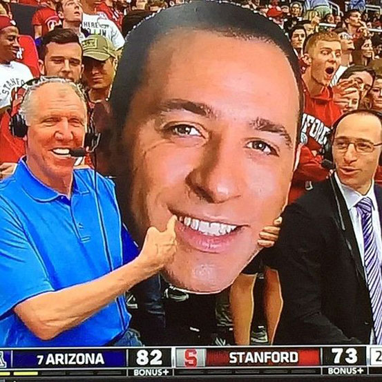 man holding big head cutout in front of his face
