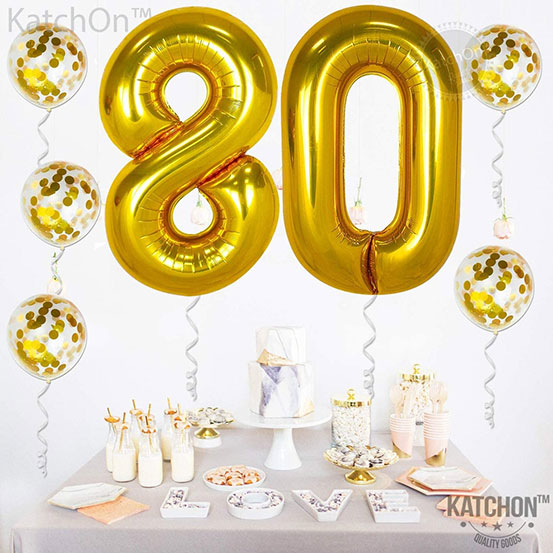 Giant number 80 balloons next to flowers