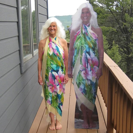 man standing next to a life size cutout of himself