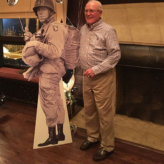 man standing next to a life size cutout of himself