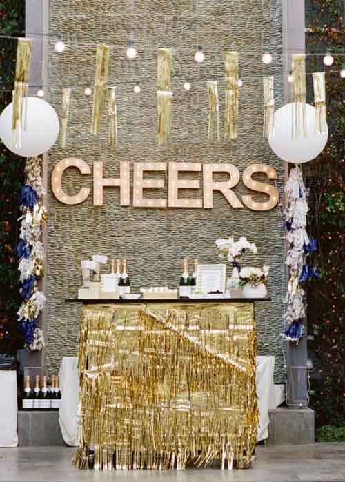 dessert table with letter backdrop