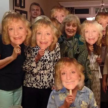 partygoers with custom fan faces of the birthday boy/girl