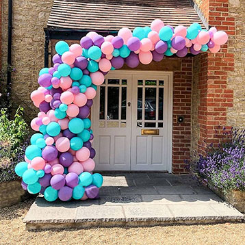 blue purple pink balloon garland at house entrance