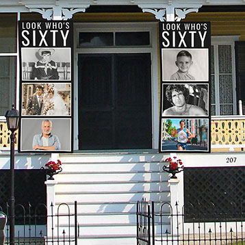 look who's 60 photo banners at house entrance
