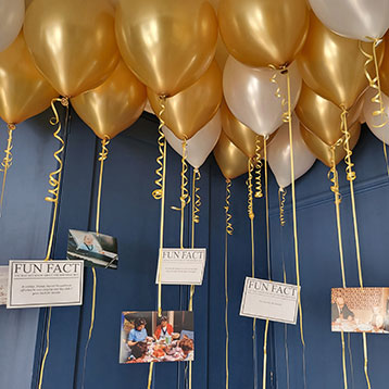 Fun Facts photos hanging from balloon strings
