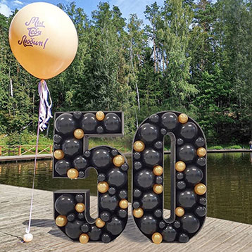 freestanding balloon mosaic next to a lake