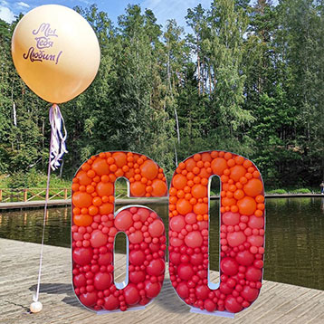 freestanding 60 balloon mosaic next to a lake