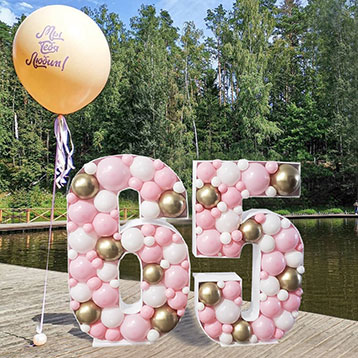 freestanding 65 balloon mosaic next to a lake