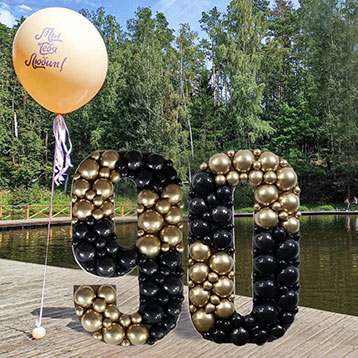 freestanding 90 balloon mosaic next to a lake