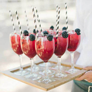Red berry cocktails in glasses on a tray