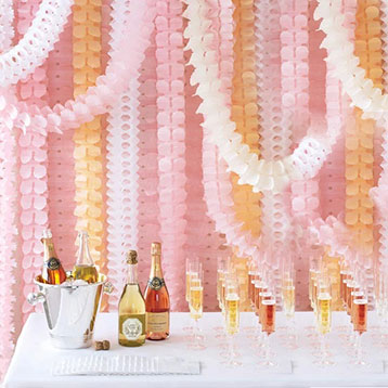 pink orange and white paper leaf gardland dessert table backdrop
