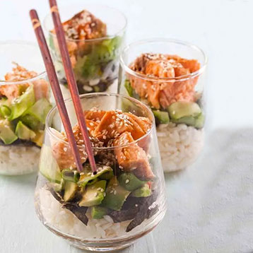 salmon and rice served in tumblers with chopsticks